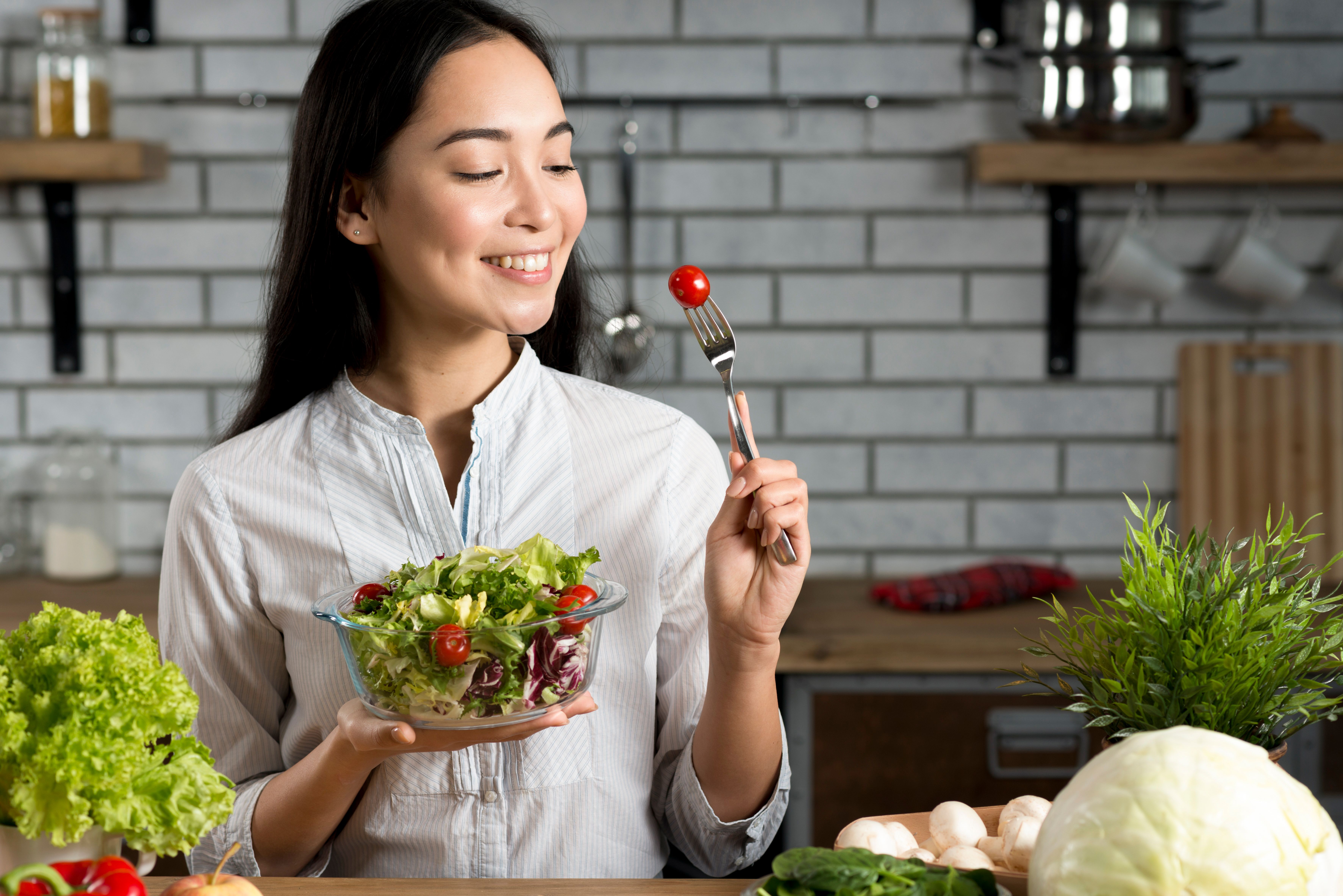 smiling-asian-woman-with-healthy-salad-kitchen.jpg